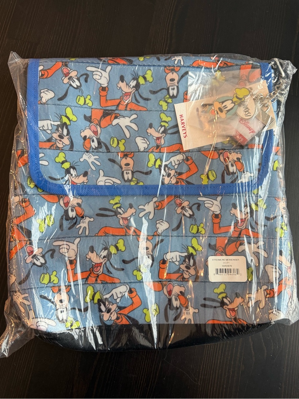 Harvey's Seatbelt Goofy All-Over Print Crossbody in Light Blue and Orange